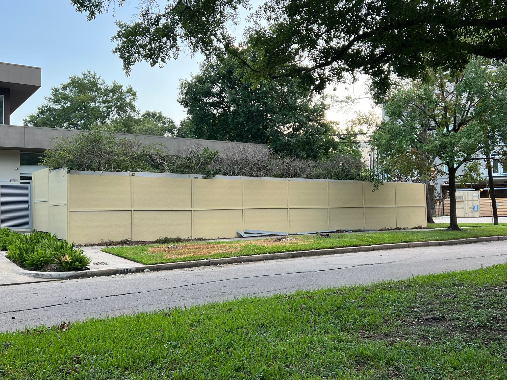 Tall cream-coloured solid panel fence along a residential street in League City