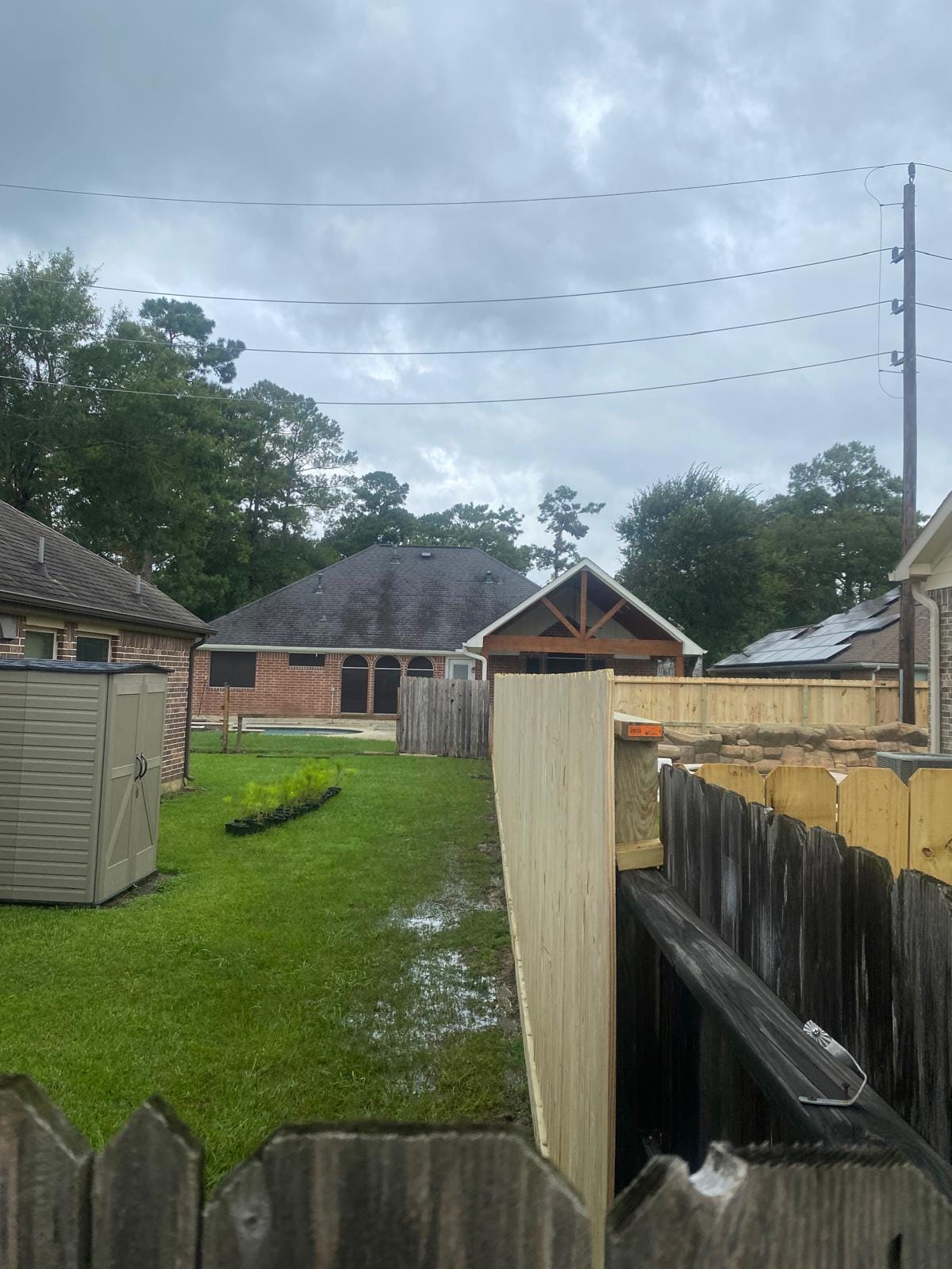 Older wood fence beside garden sheds