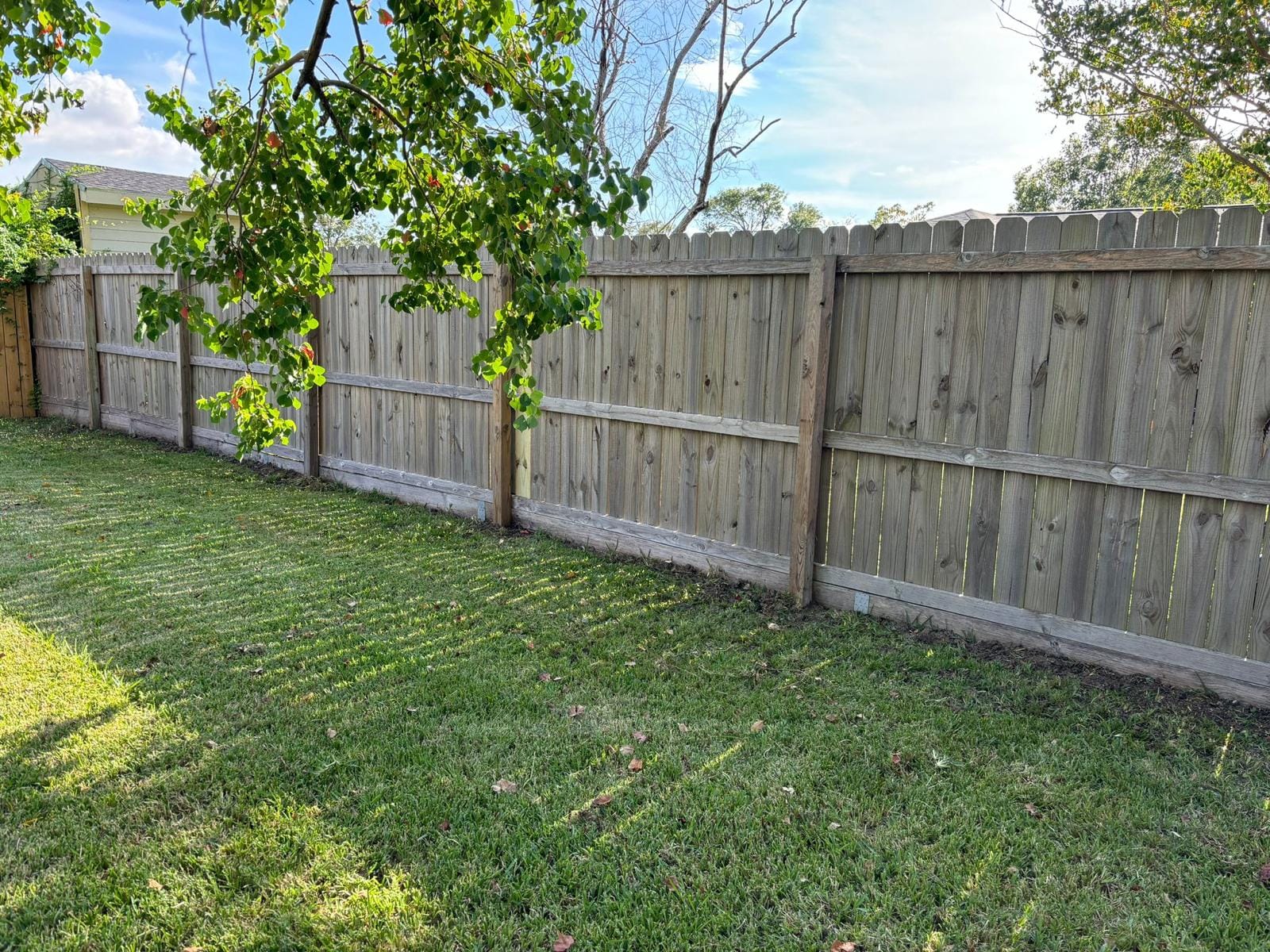 Weathered wood fence on a concrete base, Kemah, Texas