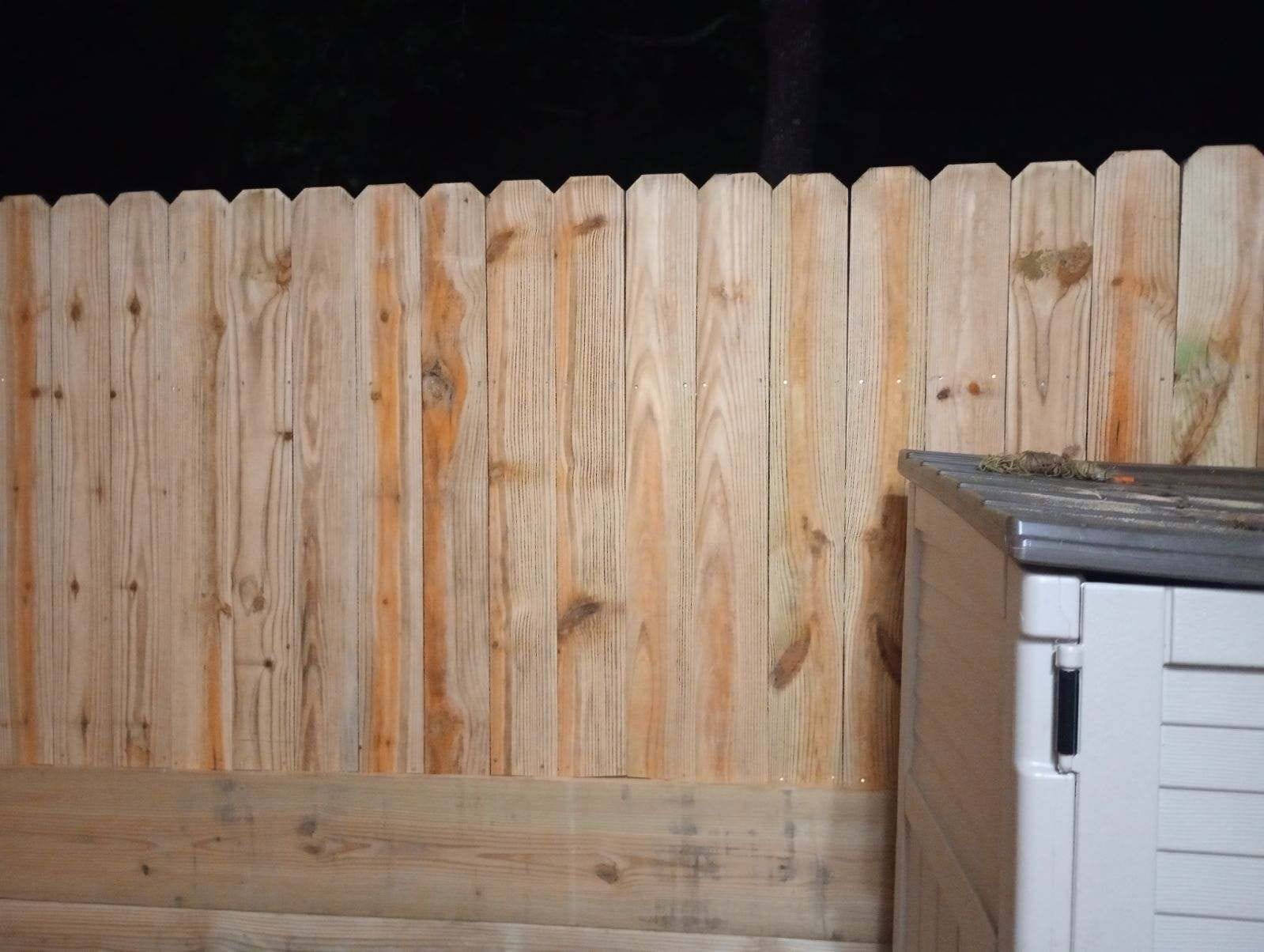 New wood privacy fence photographed after dark