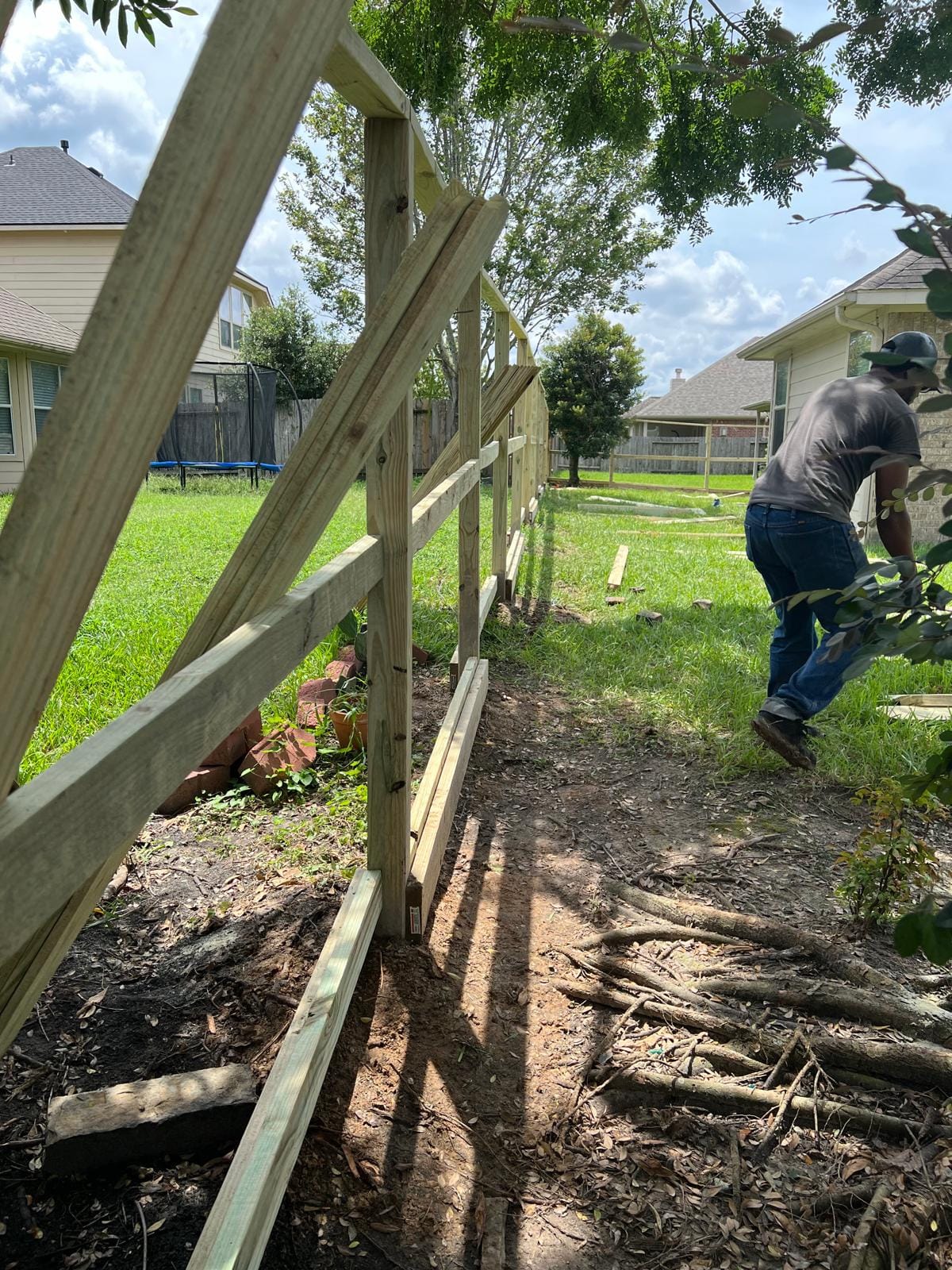 Installer working on the rail frame of a wood fence