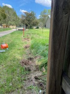 Fence post set in an open lot before installation
