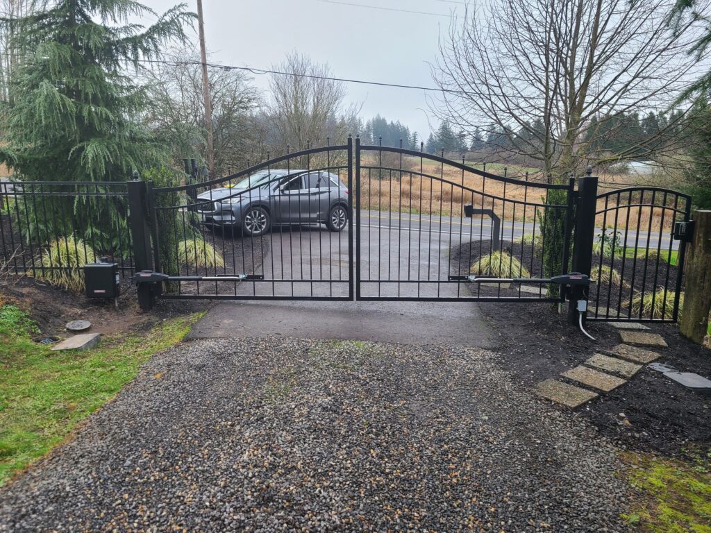 Arched double iron driveway gate with automatic operators