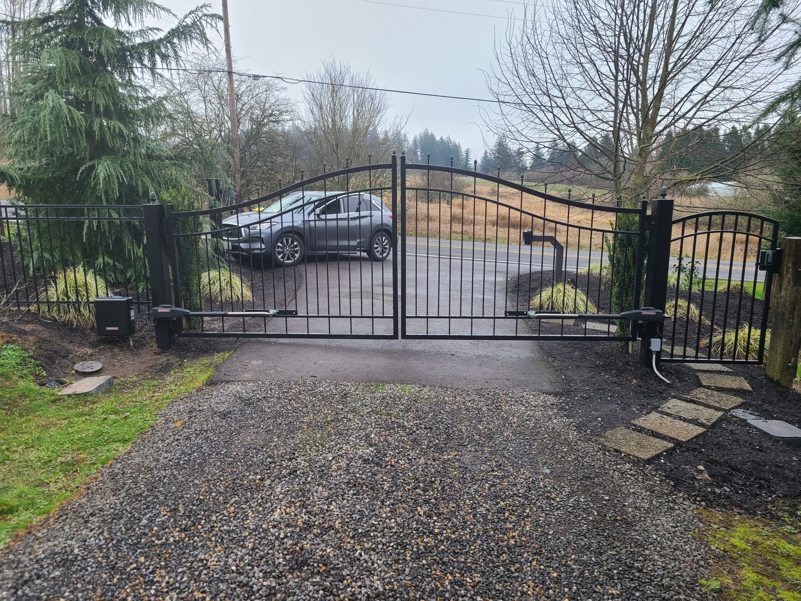 Arched double iron driveway gate with automatic operators