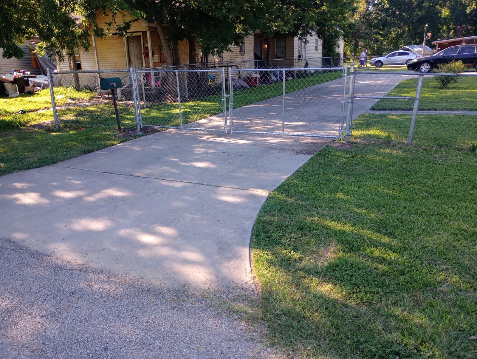 Galvanized chain link driveway gate at a residential property