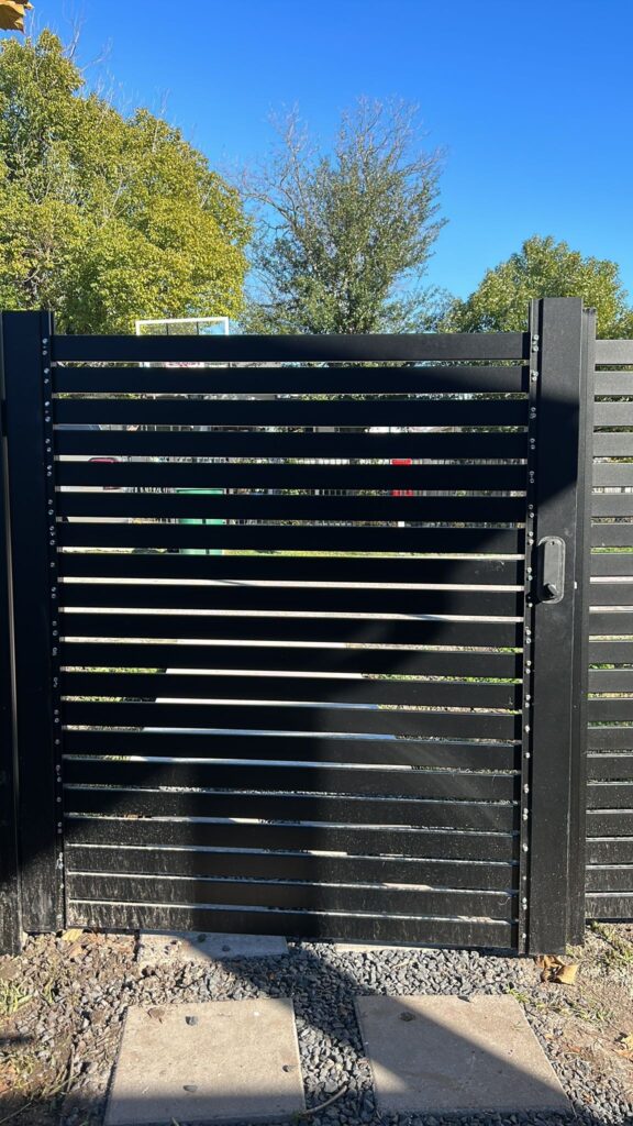 Black metal slat privacy screening fence