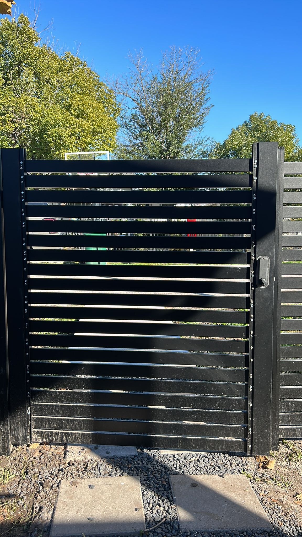 Black metal slat privacy screening fence