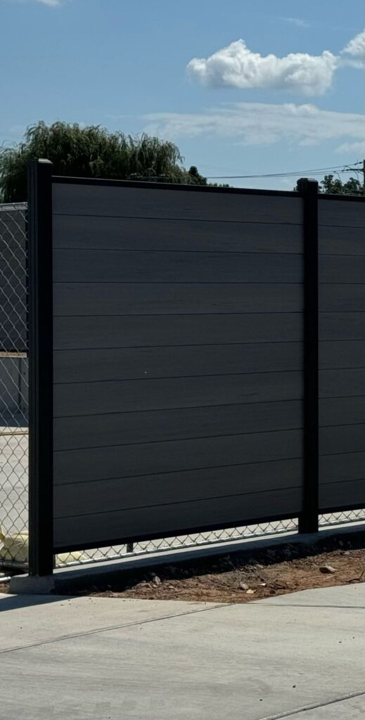 Black composite fence panel installation
