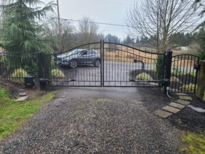 Arched double iron driveway gate with keypad access