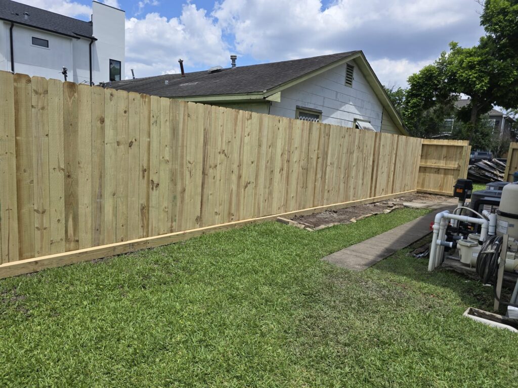 Wood fence finished evenly on both sides between two properties