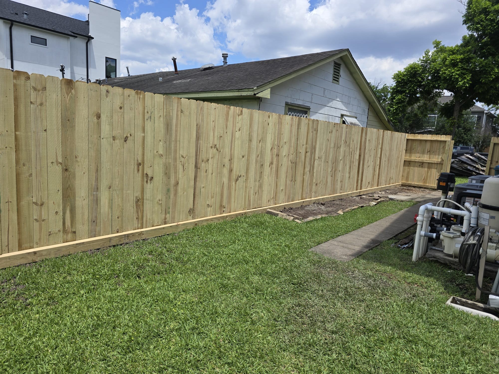 Wood fence finished evenly on both sides between two properties