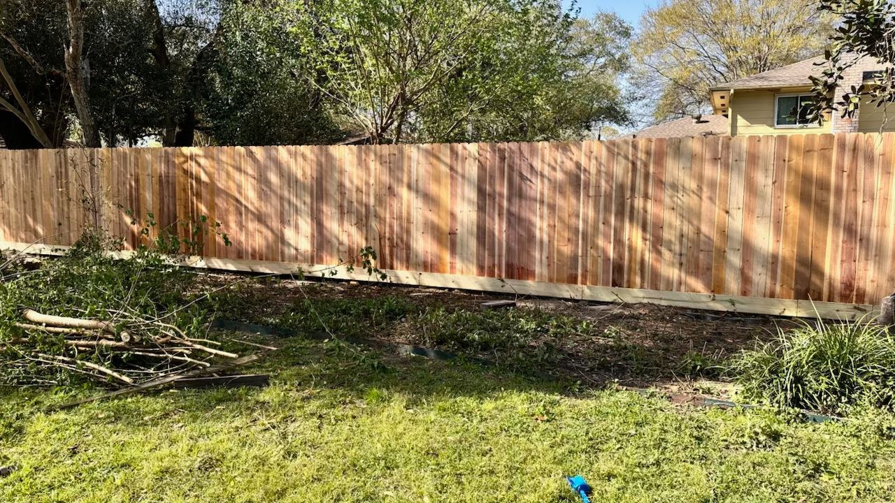 Newly installed cedar privacy fence adding curb appeal to a home