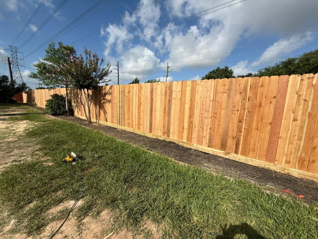 Wood fence installation in progress in a backyard