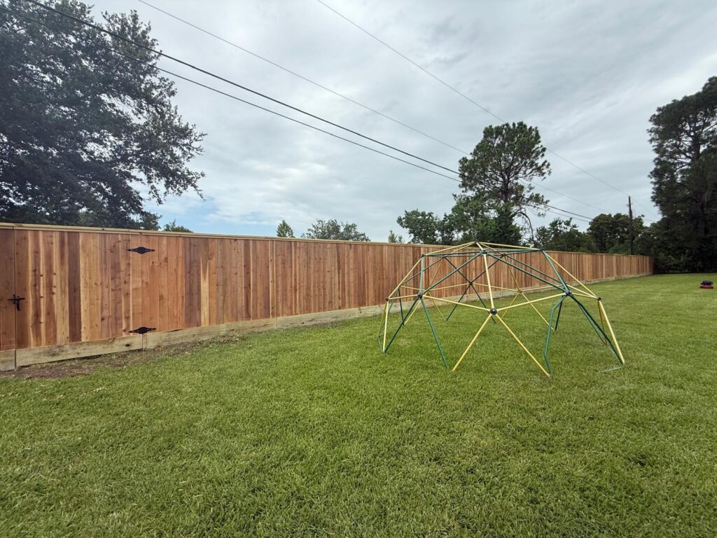 Wood privacy fence installed along a residential backyard property line