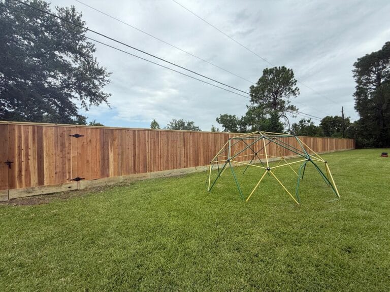 Wood privacy fence installed along a residential backyard property line