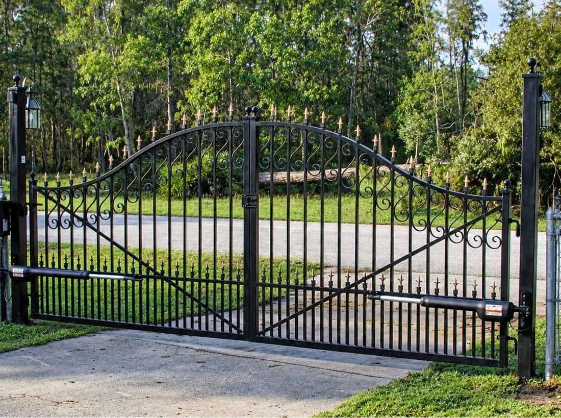 Arched iron gate in a landscaped setting