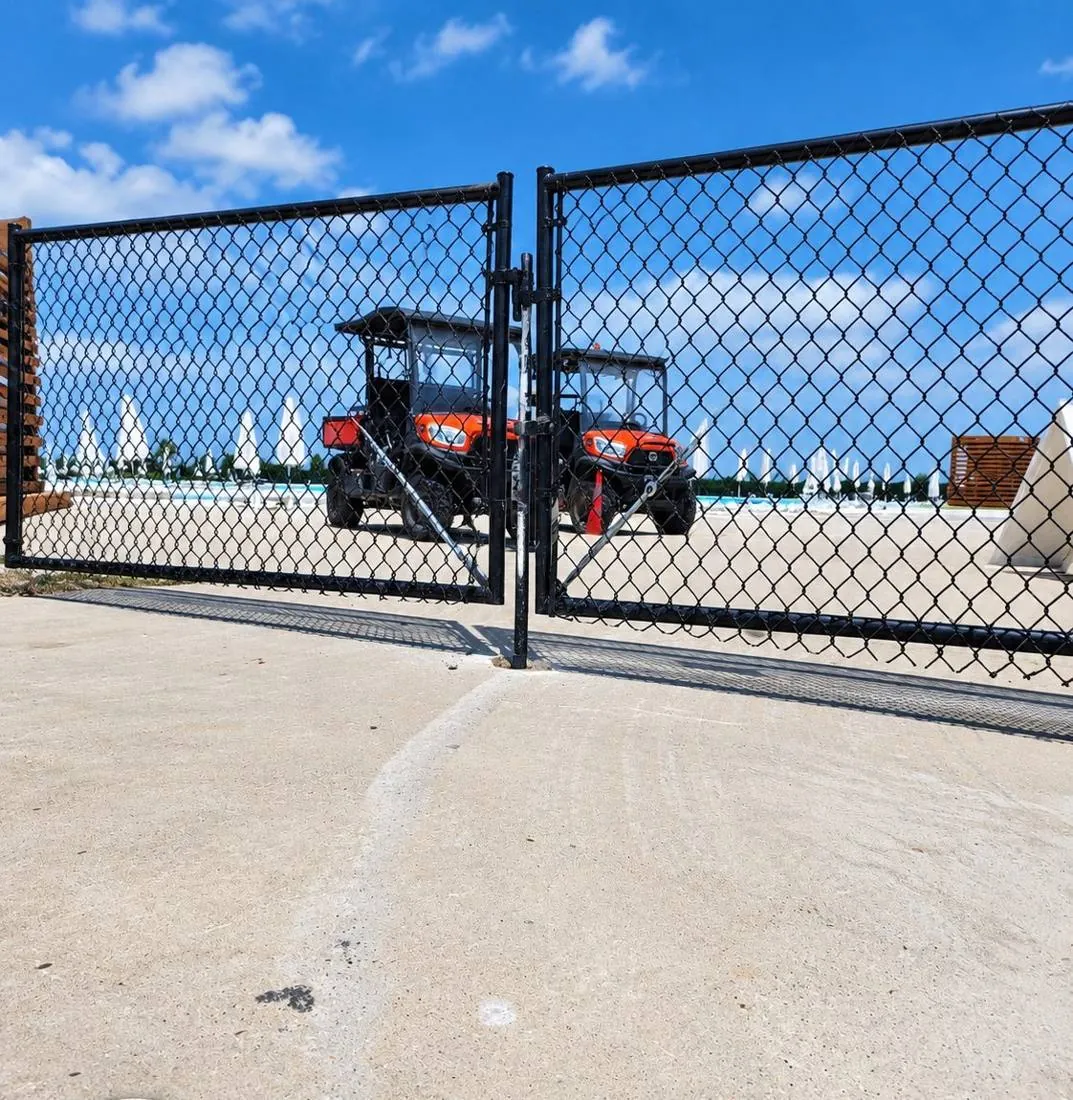 Black chain link double gate at a commercial lot
