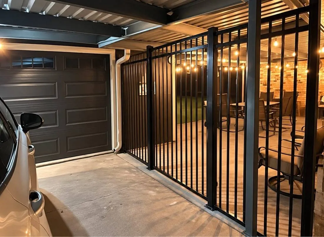 Black iron gate across a covered driveway