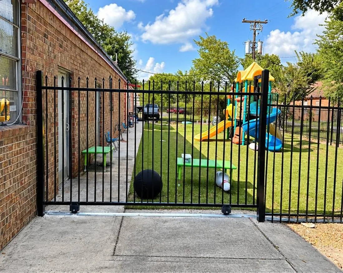 Black iron walk gate at a backyard play area