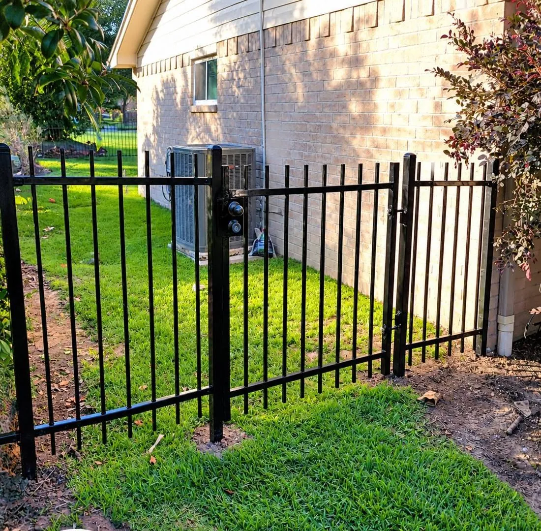 Black ornamental fence between homes
