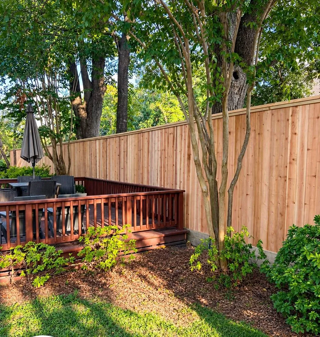 Cedar fence beside a deck and landscaping