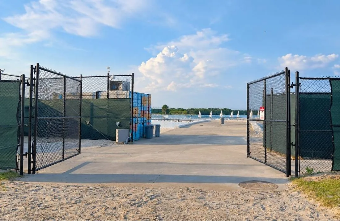 Chain link vehicle entrance gates standing open