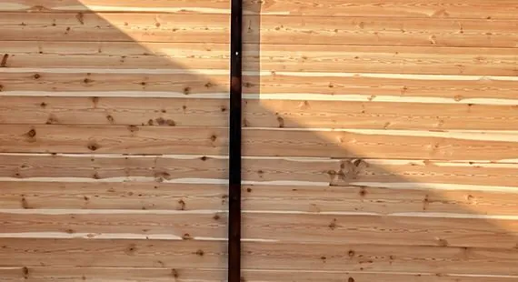 After: horizontal cedar double drive gate on a black steel frame