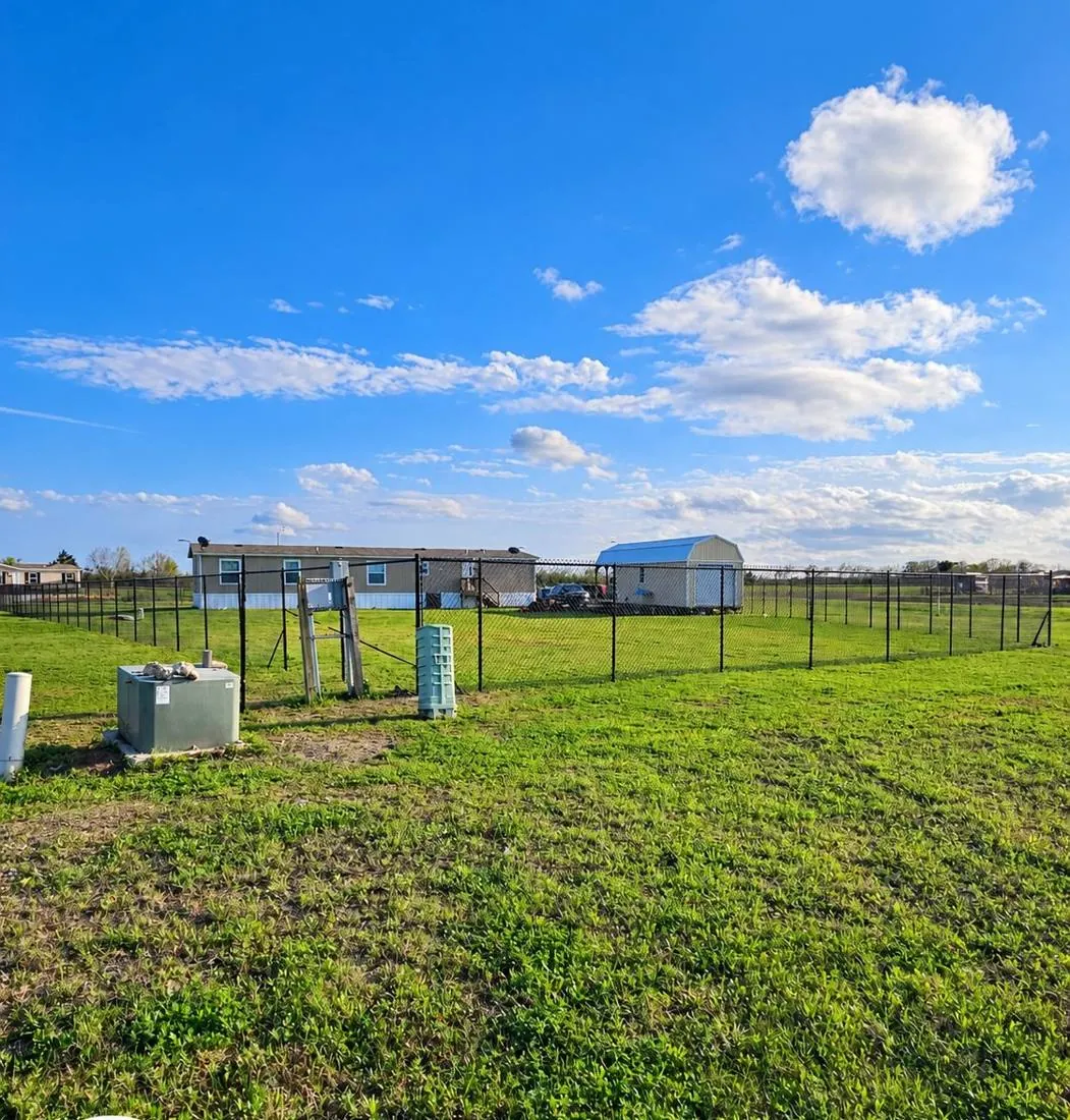 Galvanized chain link fence in an open field