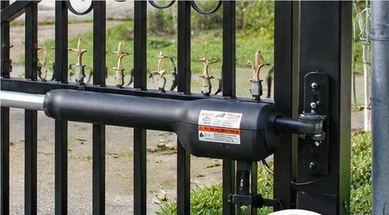 Gate operator mounted on an iron gate