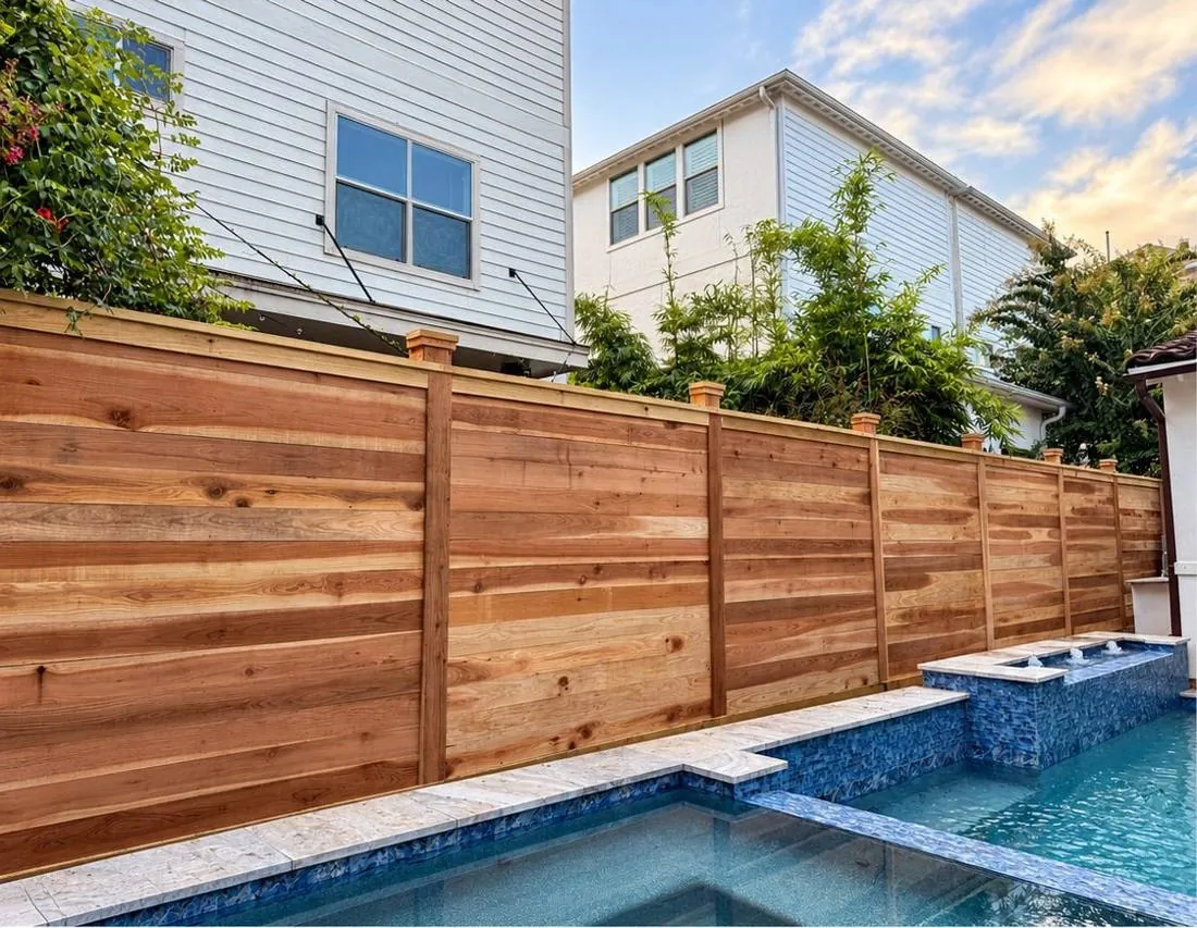 Horizontal cedar privacy fence beside a pool