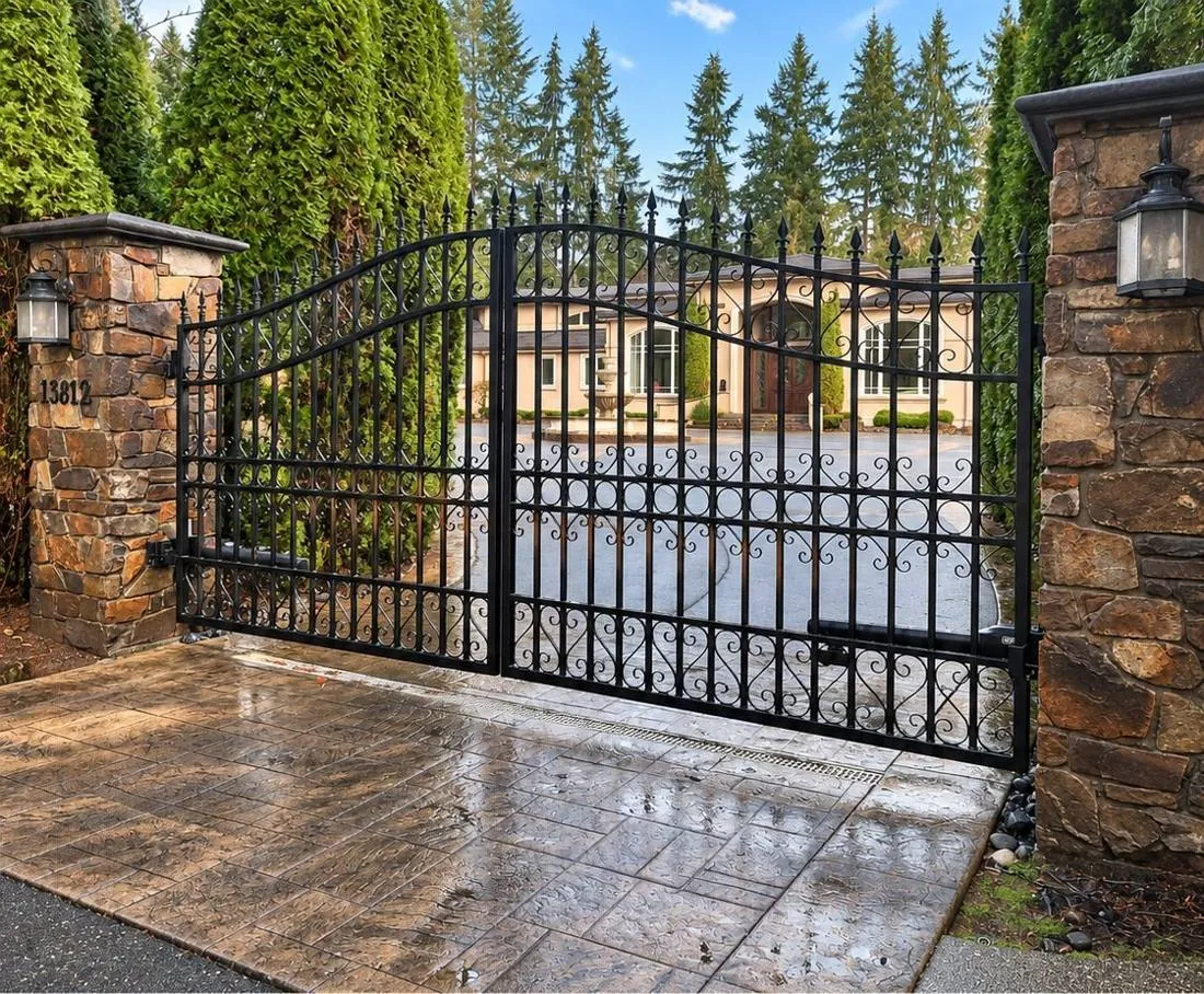 Iron entrance gate in a wooded setting
