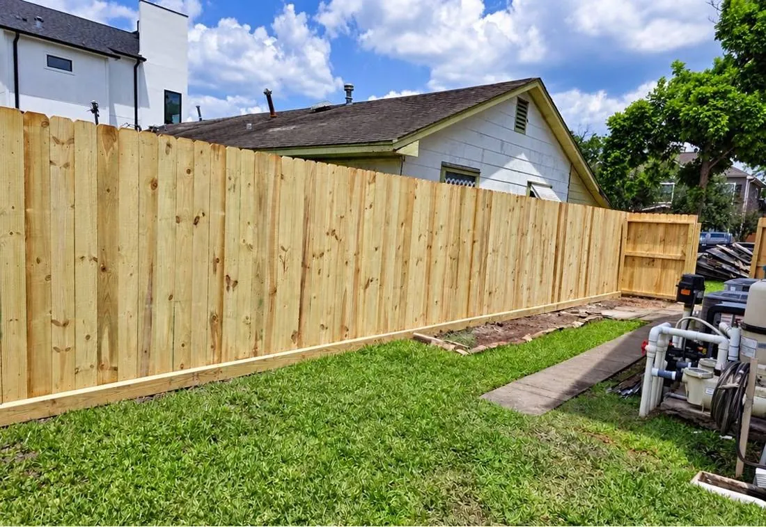 Long wood fence near residential rooflines