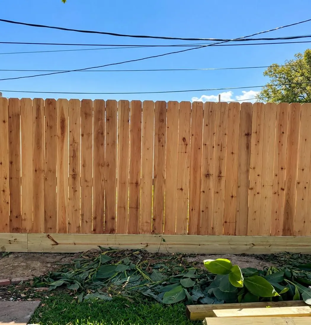 Pine privacy fence across a backyard lawn