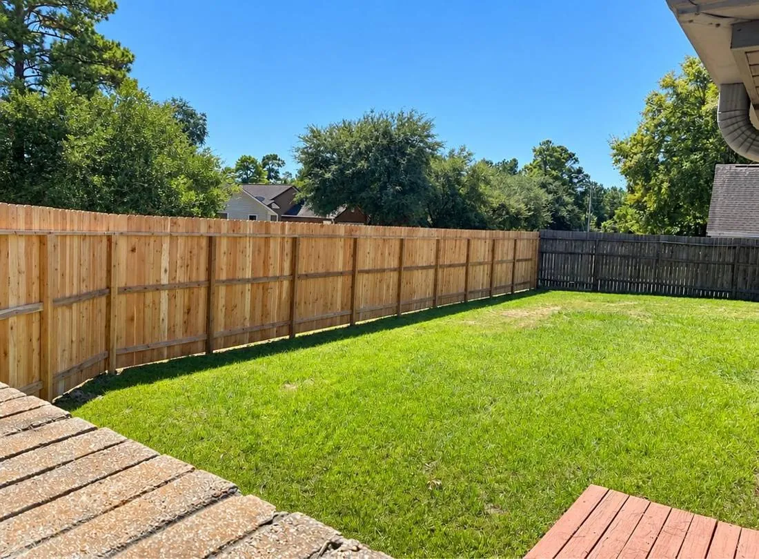 Pine privacy fence around a wide lawn
