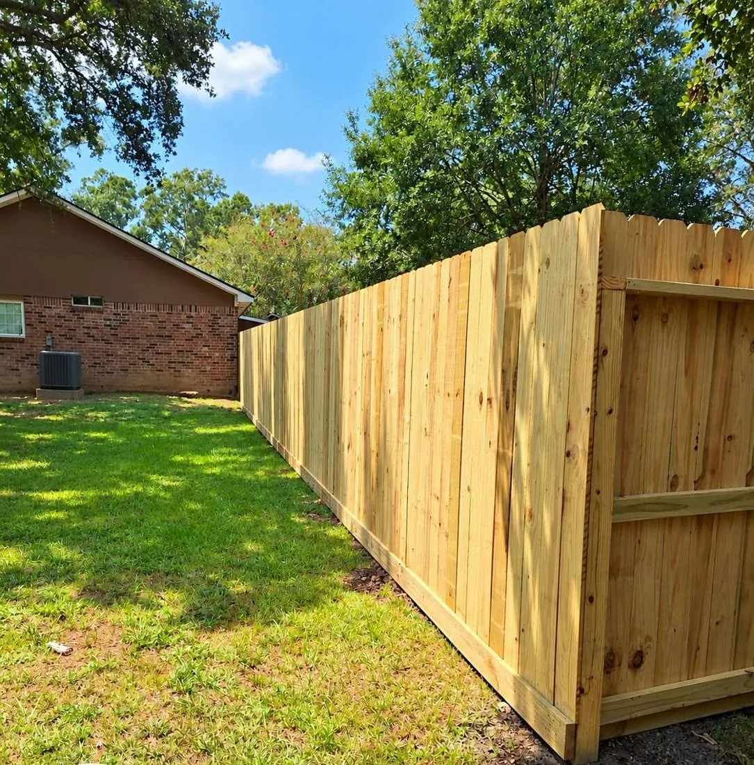 Pine privacy fence turning a corner along a lawn