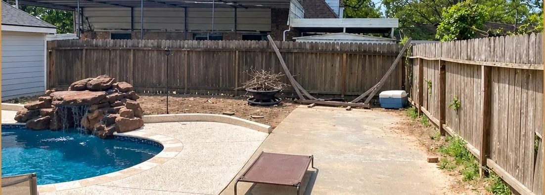 Before: weathered gray board fence around the same pool patio