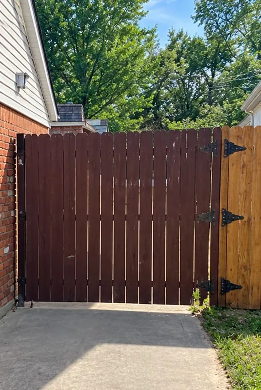 Before: dark-stained vertical wood gate in the same opening