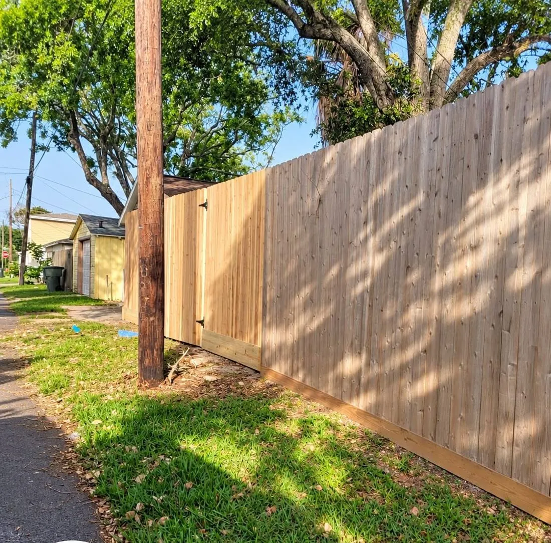 Wood fence along a sidewalk